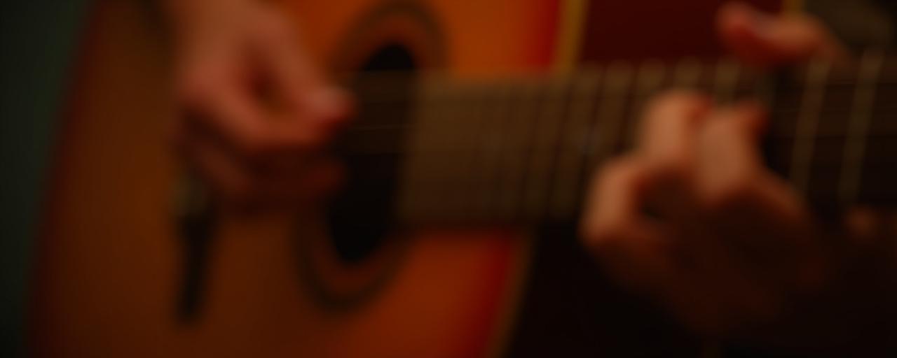 Close up of professional guitarists hands on a fretboard